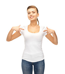 Image showing smiling woman pointing at blank white t-shirt