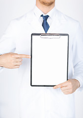 Image showing doctor pointing at blank white paper