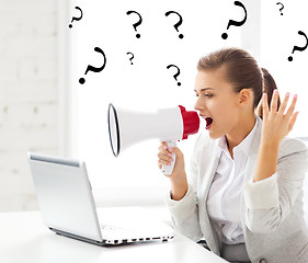 Image showing strict businesswoman shouting in megaphone