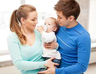 Image showing family and adorable baby with feeding-bottle