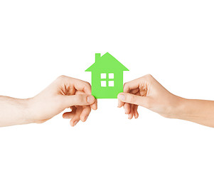 Image showing couple hands holding green house