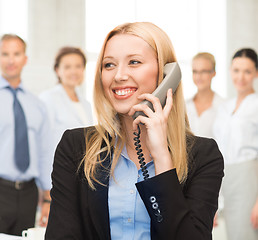 Image showing woman with phone in office