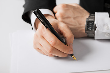 Image showing businessman writing something on the paper