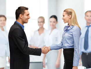 Image showing man and woman shaking their hands