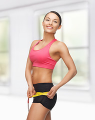 Image showing sporty woman with measuring tape