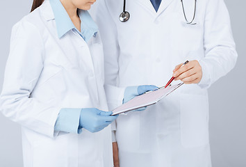 Image showing nurse and male doctor holding cardiogram