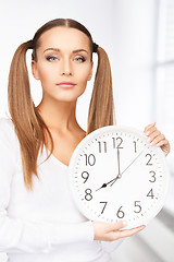 Image showing woman holding big clock