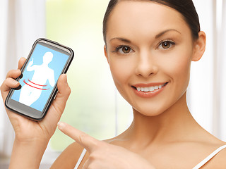 Image showing woman pointing at smartphone with application