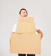 Image showing young man carrying carton boxes