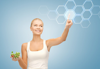 Image showing woman with salad and virtual screen