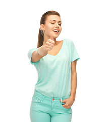 Image showing smiling girl in color t-shirt showing thumbs up