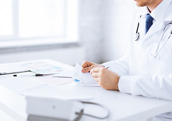 Image showing male doctor writing prescription paper