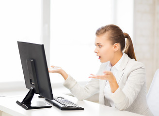 Image showing stressed student with computer in office