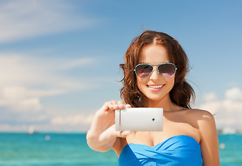 Image showing woman in bikini with phone