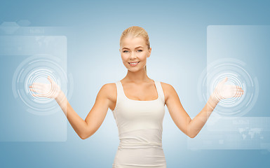 Image showing businesswoman touching virtual screen