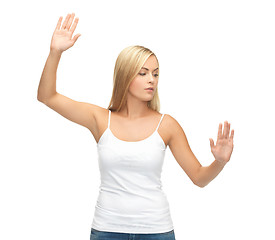 Image showing woman in white t-shirt pressing imaginary button