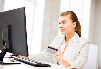 Image showing businesswoman with laptop using credit card