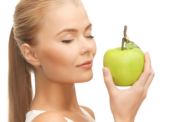 Image showing woman smelling apple