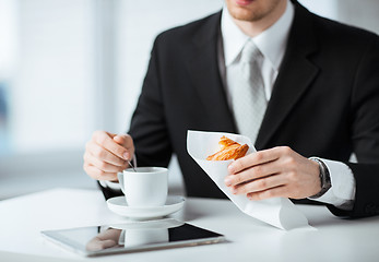 Image showing man with tablet pc and cup of coffee