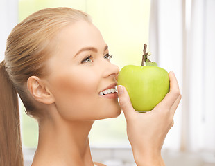 Image showing woman smelling apple