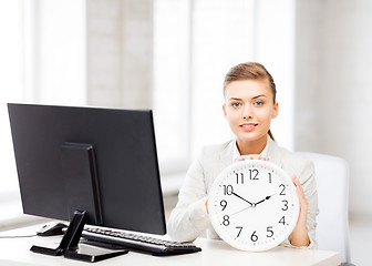 Image showing attractive businesswoman with white clock