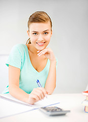 Image showing student girl with notebook and calculator