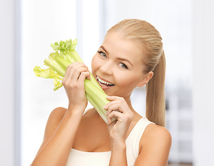 Image showing woman biting piece of celery or green salad