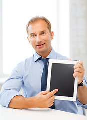 Image showing smiling businessman with tablet pc in office
