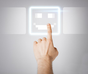 Image showing hand touching virtual screen with smile button