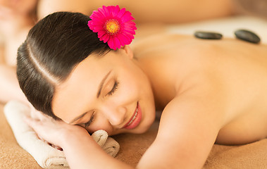 Image showing woman in spa with hot stones