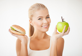 Image showing woman with apple and hamburger