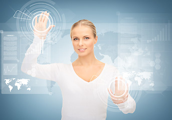 Image showing businesswoman touching virtual screen
