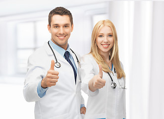 Image showing young team of two doctors showing thumbs up