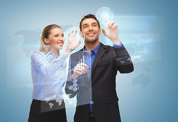 Image showing two business people working with virtual screen