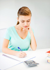 Image showing student girl with notebook and calculator