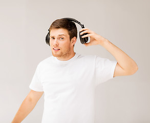 Image showing man with headphones listening loud music