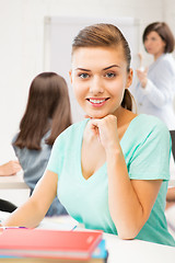 Image showing happy smiling student girl with books at school