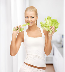 Image showing woman biting lettuce