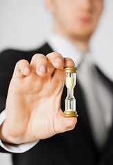 Image showing man hand holding hourglass