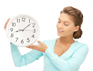 Image showing woman with wall clock