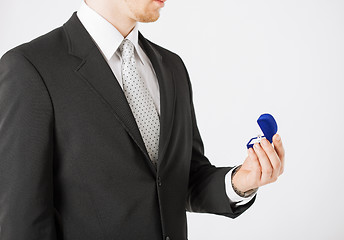 Image showing man with gift box and wedding ring