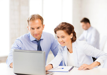 Image showing man and woman working with laptop in office