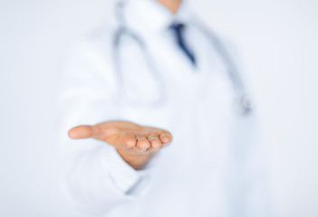 Image showing male doctor holding something in his hand