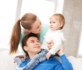 Image showing happy parents playing with adorable baby