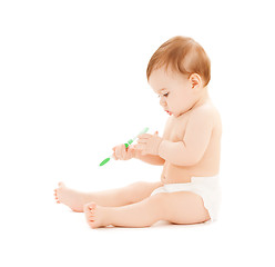 Image showing curious baby brushing teeth