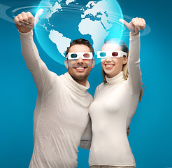 Image showing woman and man in 3d glasses looking at globe model