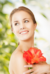 Image showing beautiful woman with red lily flower