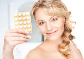 Image showing young woman with pills