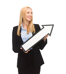 Image showing smiling businesswoman with direction arrow sign