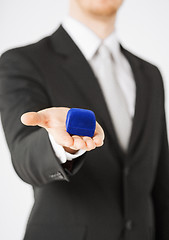 Image showing man with gift box in suit